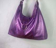 "Hobo in Metallic Purple Leather - NOW with 3 pockets! Now 2 sizes available - Premium leather with designer cotton lining - Now also available with Gunmetal hardware * This bag is handmade from strong, soft metallic leather. * Fully lined in a beautiful designer fabric of your choice (see picture). Or please ask if you would like other options. * 3 inside pockets (including zipper pocket). * One Large compartment. * High quality, double sided, strong adjustable strap. * Strong Bag zipper closur Purple Leather Hobo Bag For Travel, Purple Travel Hobo Bag, Purple Leather Hobo Tote Bag, Purple Tote Hobo Bag, Purple Soft Leather Shoulder Bag For Everyday, Daily Use Purple Soft Leather Shoulder Bag, Everyday Purple Soft Leather Bag, Purple Hobo Bag With Removable Pouch For Daily Use, Purple Satchel Hobo Bag For Everyday