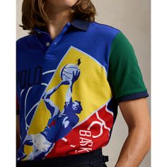 An American style standard since 1972 the Polo shirt has been imitated but never matched. Over the decades Ralph Lauren has reimagined his signature style in a wide array of colors and fits yet all retain the quality and attention to detail of the iconic original. This color-blocked version features a basketball player graphic printed at the front. Retro Graphic Print Polo Collar Tops, Classic Blue Shirt With Graphic Print, Multicolor Graphic Print Polo Collar Top, Multicolor Polo Collar Top With Graphic Print, Multicolor Graphic Print Top With Polo Collar, Classic Fitted Polo Shirt With Graphic Print, Classic Polo Collar Top With Graphic Print, Ralph Lauren Multicolor Cotton Top, Fitted Multicolor Ralph Lauren Shirt