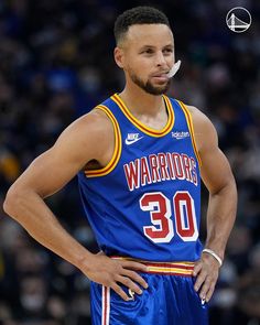 a basketball player standing with his hands on his hips and looking at the camera while wearing a blue uniform