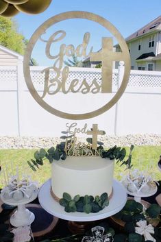 a cake sitting on top of a table covered in greenery