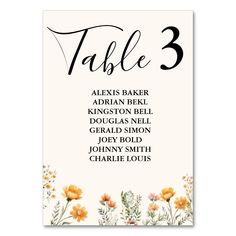 a table number card with flowers on the front and bottom, in black ink that reads table 3