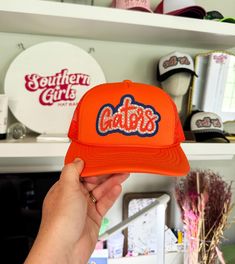 This listing is for the Gators trucker hat in orange. Includes the Gators script patch with rhinestones. I can make other custom school mascot or name hats too so just send me a message and we can work out a personalized hat just for you! DETAILS- * This hat is one size with an adjustable SnapBack that is adjustable from 20in. - 23.5in. * The color of this hat is orange * The material of the hat is polyester with hand paint and rhinestones glued on REFUNDS AND CANCELLATIONS- Every hat is handmade by me as a result, a slight variation can occur from the picture with patch size or placement. If you have any problems with your hat please message me within 24 hours of receiving your order and I'd be happy to help! No refunds or exchanges will be accepted after. PRODUCTION TIME- The turn around Personalized Hat, College Hats, Trendy Hats, Bling Hat, Southern Girls, Trendy Hat, University Of Florida, Florida Gators, Hand Paint