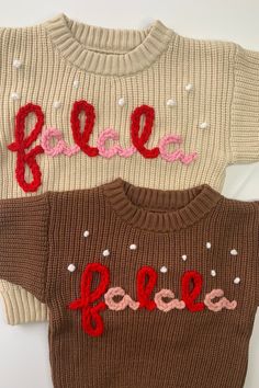 two sweaters with the word peace written in red, white and pink on them