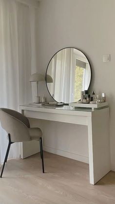 a white desk with a mirror and chair