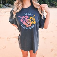 Embrace the tropical vibes and VSCO-inspired style with the Comfort Colors "Aloha Hibiscus" Shirt. This trendy tee is a summer essential, perfect for beach days and sunny adventures. With its hibiscus flower design and beachy aesthetic, it adds a touch of tropical fashion to your wardrobe. Let the vibrant colors and beach vibes transport you to paradise. All clothing and accessories from The Southern Thistle are handmade-to-order, just for you! ☺️ Experience the epitome of comfort with Comfort C Hibiscus Flower Design, Hibiscus Shirt, Beachy Aesthetic, Tropical Fashion, Beachy Vibes, Summer Essential, Hibiscus Flower, Trendy Tee, Tropical Vibes