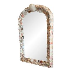 a mirror made out of seashells and shells