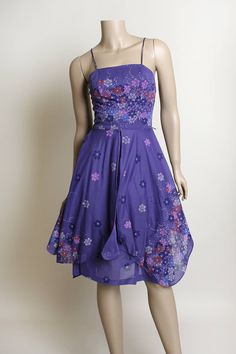 "FREE DOMESTIC SHIPPING! <3 ♥ Lovely vintage 1970s purple floral print, sheer sundress! ♥ Zips in the back. ♥ Fitted waist, with a double layered, sheer overlay skirt. Square angle cut give it a unique look, and great twirls! ♥ Spaghetti straps! Such a pretty floral print! ♥ In great condition! Light lavender purple polyester. Montgomery Ward tag. * measurements when flat * Armpit to armpit - 15\" across Waist - 12\" across Hips - 20\" across Bodice length - 17\" Length - 41\" Fits like a sma Purple Retro Sleeveless Dress, Retro Purple Sleeveless Dress, Vintage Purple Floral Print Dress, Retro Purple Dress For Spring, Retro Purple Spring Dress, Purple Retro Spring Dress, 1970s Fitted Purple Dress, Fitted Purple 1970s Style Dress, Fitted 1970s Style Purple Dress