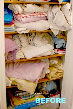 a closet filled with folded clothes and other items that have been left on the shelves