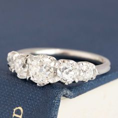 Modeled after antique diamond half-hoop bands from the Georgian and Victorian eras, this 5-stone band is set with chunky and charming old mine cut diamonds in platinum! The diamonds are bright, sparkly, twinkly - so elegant on the finger. This particular parcel is graduated in size, which maximizes diamond coverage in a subtle and unique way. We love how they stack with other bands just as much as we love ‘em when worn by themselves. Platinum Size 5.75 & Resizable Measures: 18.50mm W x 4.25mm H Modern Mens Rings, Old Mine Cut Diamond, Antique Signs, Jewel Necklace, Antique Inspiration, Antique Diamond, Mens Band, Vintage Band, Men's Rings