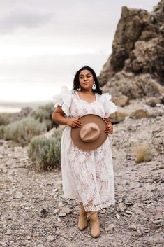 Embrace the charm of autumn in the Hattie Dress in White Lace. This enchanting dress features a round neckline, short flutter sleeves, and a smocked bodice for effortless elegance. The midi-length skirt adds a touch of sophistication, making it the perfect dress for your seasonal gatherings. (plus did we mention she's maternity-friendly?!) coastal cowgirl, smocked bodice, beach photoshoot, mommy and me, summer dress, fall dress, rock, coastal aesthetic, flutter sleeve, smocked bodice Feminine Midi Dress With Ruffle Sleeves For Garden Party, Bohemian Midi Dress With Ruffle Sleeves For Spring, Bohemian Midi Dress With Ruffle Sleeves, Bohemian Midi Dress With Flutter Sleeves For Garden Party, Bohemian Midi Dress With Flutter Sleeves, Modest Midi Dress With Lace Trim, Modest Summer Midi Dress With Ruffle Sleeves, Feminine Flutter Sleeve Midi Dress For Daywear, Feminine Midi Dress With Flutter Sleeves For Daywear