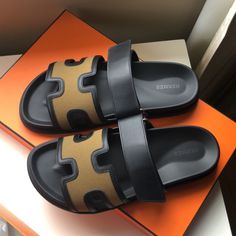 Hermes H Logo Black And Khaki Leather Chypre Sandals Flats Brand New With Box Size 41.5. With The Box And 2 Dust Bags. 100 % Authentic. Have The Proof Of Purchase From Poshmark. Luxury Sandals With Leather Trim For Summer, Luxury Leather Trim Sandals For Summer, Designer Open Toe Sandals With Leather Trim, Luxury Black Calf Leather Slides, Luxury Leather Sandals With Leather Trim, Designer Calf Leather Slides With Round Toe, Luxury Black Sandals With Rubber Sole, Luxury Black Slides With Leather Sole, Luxury Black Sandals With Leather Lining