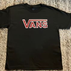 Boys Vans Black/Red Short Sleeve T-Shirt. Size Small. Brand New Without Tags! Black Graphic Print T-shirt For School, Vans Black Tops With Graphic Print, Vans Black Graphic Tee, Vans Black Top With Graphic Print, Vans Black Crew Neck T-shirt, Black Vans Crew Neck T-shirt, Black Vans Tops With Graphic Print, Black Crew Neck T-shirt By Vans, Black Crew Neck T-shirt For School Spirit