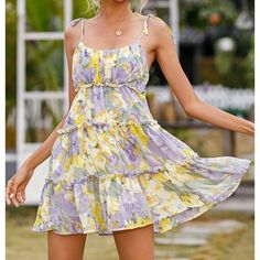 This Lush Floral Tiered Mini Dress Is Perfect For Any Occasion, Whether It's A Wedding, Party, Or Casual Outing. The Dress Features A Beautiful Floral Pattern And Is Made Of High-Quality Polyester Fabric, Making It Both Comfortable And Durable. The Dress Has A Scoop Neckline, Adjustable Straps, And A Button Closure. The Sleeveless Design And Lined Features Make This Dress Perfect For The Summer, Fall, Or Spring Seasons. The Dress Has A Fit & Flare Style, With A Tiered And Ruffled Design, Adding Casual Chiffon Sundress With Ruffles, Chiffon Ruffle Sundress For Vacation, Purple Ruffled Sundress For Summer, Casual Tiered Chiffon Mini Dress, Purple Ruffled Sundress For Beach, Casual Chiffon Dress With Ruffled Straps, Spring Purple Sundress With Ruffles, Casual Purple Ruffled Sundress, Casual Purple Sundress With Ruffles