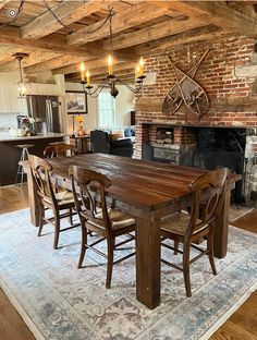 a dining room table and chairs in front of a fire place with an old brick fireplace