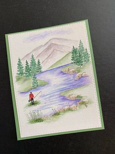 a watercolor painting of a man fishing on a lake with mountains in the background