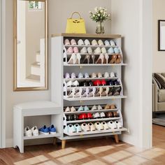 a white shoe rack filled with lots of pairs of shoes next to a mirror on the wall