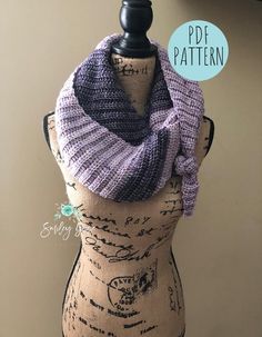 a mannequin wearing a purple and black knitted cowl with the words poof pattern on it