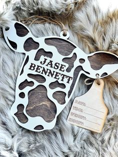 a cow shaped ornament with a tag on it that says,'jase bennet '