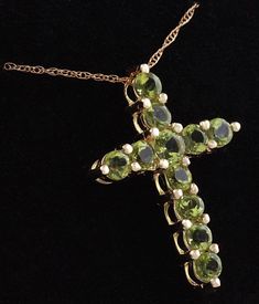 1.20 Carat Natural Green Peridot 14K Solid Yellow Gold Cross Pendant with Chain Amazing looking piece! Suggested Replacement Value: Approx. $1600.00 Total Natural Round Cut Green Peridots Weight: 1.20 Carat Chain Length is: 16 inches Pendant measures: Approx. 25 x 18.4mm Total item weight is: Approx. 2.1g Disclaimer: all weights, measurements and colors are approximate and may vary slightly from the listed dimensions or as seen in the image. All pictures are magnified to show the smallest of det Luxury Peridot Jewelry For Formal Occasions, Luxury Gold Jewelry With Peridot, Luxury Gold Peridot Jewelry, Luxury Yellow Gold Peridot Jewelry, Luxury Peridot Jewelry For Gifts, Formal Peridot Jewelry For May Birthstone, Formal Yellow Gold Peridot Necklace, Formal Yellow Gold Peridot Necklaces, Luxury Peridot Multi-stone Jewelry