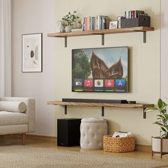 a flat screen tv sitting on top of a wooden shelf