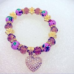 Bracelet Crystal Heart In Purple And Golden.Hand Painted Beads. Very Brilliant! Brand New In Packaging! Very Pretty! Purple Heart Beaded Bracelets, Purple Heart Beaded Bracelet For Valentine's Day, Purple Beaded Bracelets With Heart Beads For Gifts, Purple Heart Beads Stretch Bracelet, Purple Heart Jewelry With Colorful Beads, Purple Heart-shaped Jewelry With Colorful Beads, Purple Heart Charm Bracelet For Valentine's Day, Purple Adjustable Heart Bracelet For Valentine's Day, Purple Heart-shaped Beaded Bracelets For Gifts