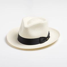 This bleached white panama fedora is a real looker. It has a teardrop crown and features wire in the brim for minor shape adjustments. Brim can be worn as shown in the picture or "snapped" up. It comes finished with a 16-Ligne grosgrain ribbon around the crown, a discrete bow and a removable Scala emblem. Additional information: Scala Panamas come with an "uncrushable" insert in the crown which prevents cracking from normal wear and tear. In addtion they come finished with a tefllon coating to repel mild water and oil based spills. Brim: 2 5/8" Crown: Front: 4" Side: 4 1/2" Upf Clothing, Outback Hat, Straw Fedora Hat, Straw Fedora, Weekend Warrior, Grade 3, Fedora Hat, Hat Sizes, Grosgrain Ribbon