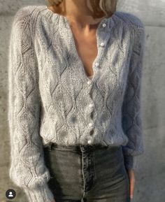 a woman with blonde hair wearing a sweater and jeans