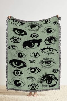 a blanket with many different eyes on it