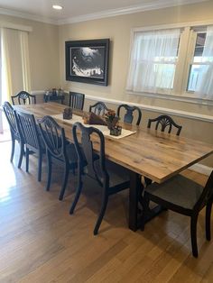 a dining room table with six chairs around it