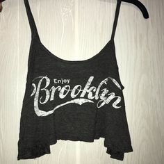 Gray Spaghetti Strap Crop Top, White Coca-Cola Themed Brooklyn Writing. No Tags, Never Worn. Perfect Condition The Tag In The Inside Is Just Worn. It’s Been Sitting In My Drawer. Summer Graphic Print Cami Top, Graphic Print Cami Tops For Summer, Casual Graphic Print Cami Tank Top, Casual Gray Cotton Camisole, Spring Letter Print Crop Top Tank Top, Spring Letter Print Crop Tank Top, Spring Letter Print Crop Top Tank, Casual Printed Cami Tank Top, Trendy Gray Tank Top For Summer