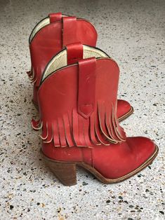 "1970's brick red fringed low height cowboy boots with a great patina by Frye. Estimated Size: US 5.5 Vintage size marked: 6 B Insole: 9\" Width: 3.25\" Heel height: 2.5\" Circa: 1970's Condition: Good vintage condition. Subtle wear, scuffs / marks. SOLD AS-IS. Follow us on Instagram for the latest----> http://instagram.com/closetcasevintage @closetcasevintage Please contact us about any questions you may have regarding condition before purchasing. Read the blog for updates, giveaways and sty Red Bohemian Boots For Fall, Bohemian Red Leather Boots, Red Western Heeled Boots With Round Toe, Red Western Style Heeled Boots With Round Toe, Red Heeled Boots For Rodeo In Fall, Red Western Heeled Boots With Snip Toe, Red Leather Heeled Boots For Rodeo, Red Round Toe Heeled Boots For Rodeo, Vintage Red Boots For Fall