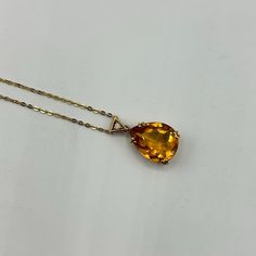 This stunning necklace features an exquisite teardrop-shaped citrine gemstone that radiates a warm, golden hue, beautifully set in 18K yellow gold. The pendant is elegantly adorned with a round diamond accent, adding a touch of sparkle and sophistication. The citrine, known for its vibrant color and clarity, is securely held by four prongs, allowing the stone to catch and reflect light from every angle. The pendant hangs gracefully from an 18-inch, 1mm chain, offering a delicate yet sturdy design that complements the vibrant gemstone. Weighing 4.47 grams, this necklace is a perfect blend of luxury and elegance, making it an ideal accessory for any occasion or a thoughtful gift for someone special. Luxury Citrine Necklaces With Diamond Accents, Yellow Gold Briolette Gemstone Drop Necklace, Luxury Gold Briolette Drop Necklace, Fine Jewelry Citrine Necklace In Yellow Gold, Formal Teardrop Pendant Necklace With Faceted Detail, Elegant Citrine Necklace With Polished Finish, Yellow Gold Citrine Pendant Necklace, Faceted Teardrop Pendant Necklace For Formal Occasions, Formal Faceted Teardrop Pendant Necklace