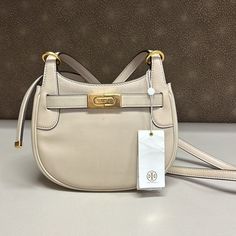 Price Is Firm New With Tag But Has Some Wear On The Bag. It’s A Store Display So It Got Scratches From Customers Trying It On. Width (At Widest): 8.25" Height: 6.5" Depth: 3.5" Shoulder Strap Drop: Adjustable, 23" White Crossbody Bag With Turn-lock Closure, Beige Crossbody Bag With Turn-lock Closure, Designer Crossbody Bags With Turn-lock Closure, Tory Burch Kira Chevron, Lee Radziwill, Tory Burch Purse, Tory Burch Crossbody, Tory Burch Kira, Brown Crossbody Bag