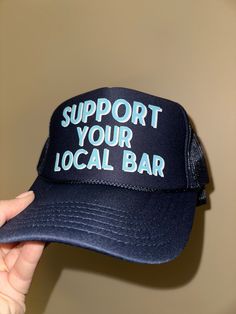 White and light blue screenprint of Support Your Local Bar on your favorite trucker hat. Adjustable snapback enclosure. Navy Flat Bill Trucker Hat For Outdoor, Navy Trucker Hat With Curved Bill For Outdoor, Blue Trucker Hat With Logo Patch For Outdoor, Trucker Hat Bar, Customizable Adjustable Blue Trucker Hat, Social Media Platforms, Trucker Hat, Screen Printing, Light Blue