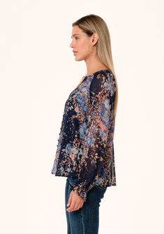 A bohemian button-front blouse in a blue floral metallic clip dot chiffon. Floral print Metallic clip dot chiffon Relaxed fit Long raglan sleeves Ruffled elastic wrist cuffs Hip length Button loop-trimmed v-neckline Self-covered loop button front Sheer Lined Special occasion bohemian blouse Add a touch of sparkle to your fall wardrobe with our ultra-dreamy blouse in a dark blue floral print, with light-catching metallic gold details throughout. Featuring long sheer sleeves with flirty ruffled cu Bohemian Blouse, Bohemian Blouses, Chiffon Floral, Floral Print Fabric, Blue Floral Print, Wrist Cuffs, Floral Print Blouses, Boho Blouses, Sheer Sleeves