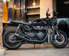 a black motorcycle parked in front of a building