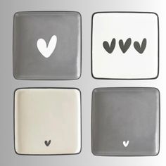 four square plates with hearts and arrows on them