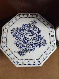 an ornate blue and white plate with stars on it