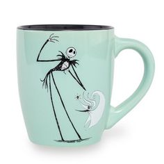 a green coffee mug with a cartoon character on it