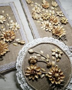 three pieces of burlap with flowers on them are sitting on a table top