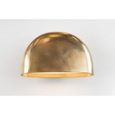 a gold dome light on a white wall