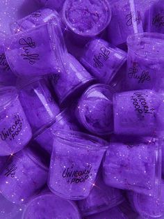 purple glitter cubes are stacked on top of each other with words written on them