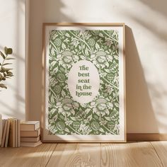 the best seat in the house print is displayed on a shelf next to books and a potted plant