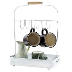 two mugs are hanging from a rack with hooks on it's sides and cups in them