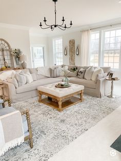 a living room filled with furniture and a chandelier