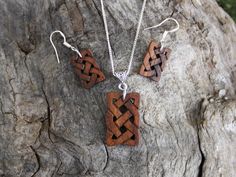 "This beautiful and unique hand-carved wooden Celtic knot jewelry set will be made for you, or a loved one, in my studio on the West of Ireland. These dainty rosewood Celtic necklace & earrings are recycled from musical instruments constructed by a local luthier. As a musician myself, I take enormous satisfaction in creating a jewelry set whose inherent wood has previously featured in a beautiful hand-made guitar. Also, part of rosewood's attractiveness is its durability and ability to stand Handmade Artisan Wood Jewelry, Artisan Wooden Jewelry As A Gift, Handmade Artisan Mahogany Jewelry, Artisan Handmade Wooden Jewelry, Artisan Wood Jewelry Gift, Artisan Handmade Mahogany Jewelry, Rustic Wooden Beads Jewelry As A Gift, Traditional Handmade Natural Wood Jewelry, Handmade Mahogany Jewelry Gift