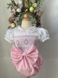 Pre-order handmade smocked romper. It takes 3-6 weeks to ship. Thank you for your patience. Thank you for supporting a small business. Clothing Care Instructions Most items can be washed safely in cold water on delicate cycle and hung to dry. If the item that you are ordering has red or another bright color in it next to a white or other light color fabric please use a Shout color catcher for the first few washes to avoid bleeding. The reds are pre-washed but they are still red and will likely h Cute Pink Bubble Romper With Smocked Back, Cute Pink Bubble Romper With Smocked Bodice, Spring Bubble Romper With Smock Detail, Spring Fitted Smocked Bubble Romper, Spring Fitted Smock Bubble Romper, Cotton Fitted Bubble Romper With Smocked Back, Fitted Smock Bubble Romper For Summer, Cute White Bubble Romper With Smocked Back, Cute White Bubble Romper With Smocked Bodice