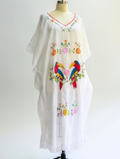 Vintage embroidered kaftan from the 1970s. Perfect coverup for summer beach or pool days. In excellent condition. Pam Royale. BOHO chic. Gorgeous lace trim. Size: Will fit large, extra large Length: 48 inches Pit to pit: 30 inches Pockets: None Lining: None Fasteneres: None Color: White with embroidery Fabric: Cotton Care: Machine wash in cool water, hang to dry Condition: Excellent Hippie V-neck Beach Tunic, White Hippie Summer Cover-up, Beach Hippie V-neck Tunic, Embroidered Kaftan For Beach Cover-up, Long Floral Embroidered Summer Kimono, Summer Floral Embroidered Kimono With Kimono Sleeves, Summer Kimono With Floral Embroidery And Kimono Sleeves, Summer Kimono With Floral Embroidery, Traditional V-neck Kimono For Summer