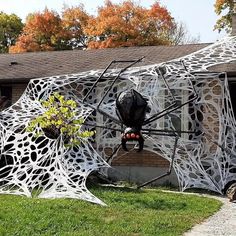 a large spider sculpture in front of a house