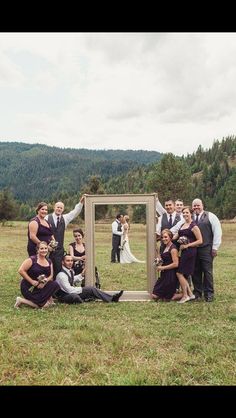 a group of people posing in front of a mirror